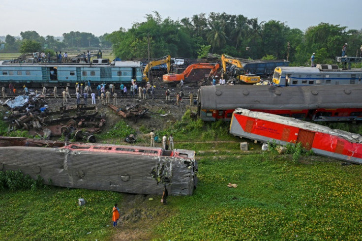 Police inspect wrecked carriages after a train disaster in the eastern state of Odisha that killed at least 288 people
