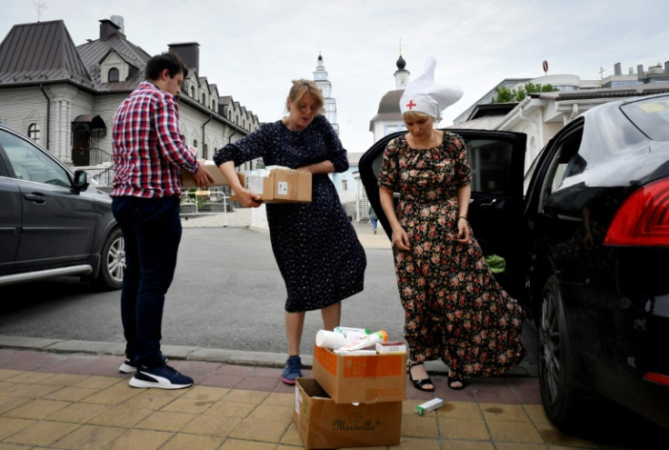 Russian volunteers carry humanitarian aid collected for evacuees