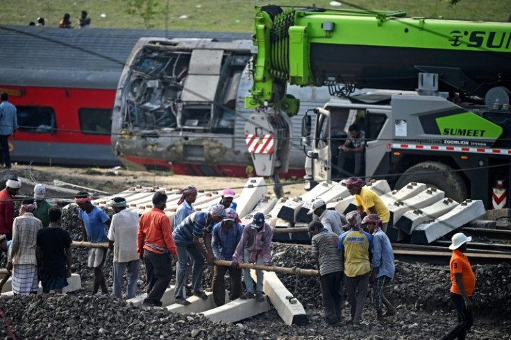 Excavators work at the site of a three-train collision near Balasore, in India's eastern state of Odisha, on June 4, 2023