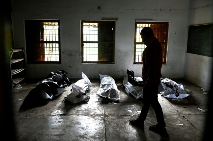 Bodies are laid out at a high school used as temporary mortuary to identify the dead recovered from the carriage wreckage