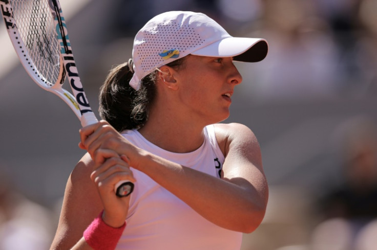 Easy does it: Iga Swiatek returns the ball to Wang Xinyu in her third round match which she won without dropping a game