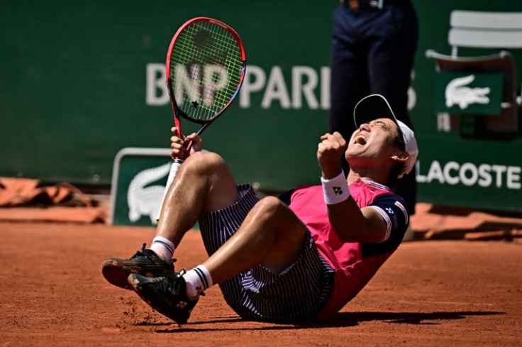 Marathon man: Japan's Yoshihito Nishioka celebrates his five-set win against Thiago Seyboth Wild in the last 32