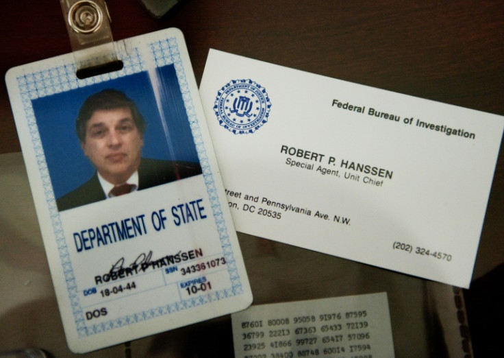 The ID bagde and business card of the former FBI agent Robert Hanssen, who spied for the Soviets, are seen inside a display case at the FBI Academy in Quantico in 2009