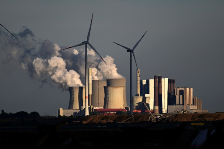 Wind turbines in front of a coal-fired power plant