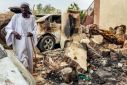 A man inspects the damage after artillery fire hit a house in Khartoum's Azhari district