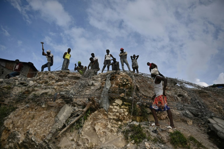 People work amongst debris in Jeremie, Haiti, after an earthquake hit western Haiti