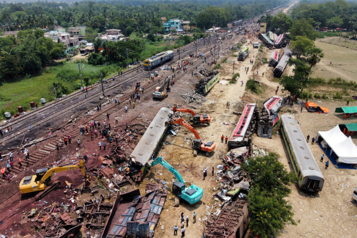 A drone view shows diggers remove damaged coaches following trains collision in Balasore