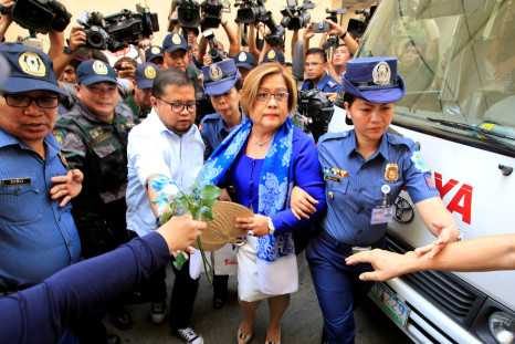 Philippine police escort Leila de Lima, a senator detained on drug charges, on her way to a local court to face an obstruction of justice complaint in Quezon city, metro Manila