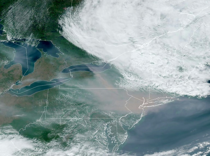 This National Oceanic and Atmospheric Administration (NOAA) satellite handout image shows smoke (C) from Canada's wildfires over the the US East Coast,  on June 7, 2023