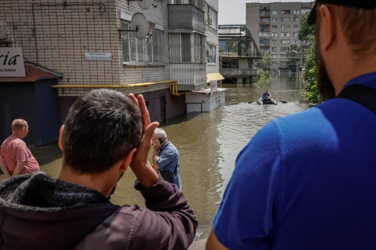 Local residents are seen during an evacuation from a flooded area after the Nova Kakhovka dam breached in Kherson