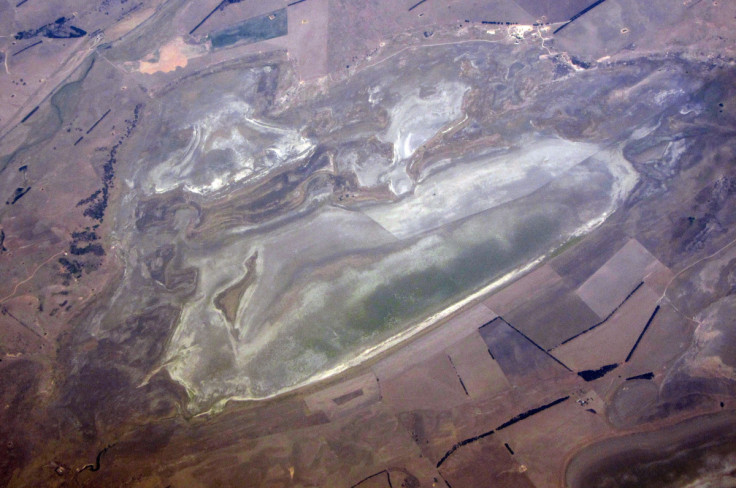 A lake with low levels of water can be seen in a drought affected farming land on the outskirts of Canberra in Australia