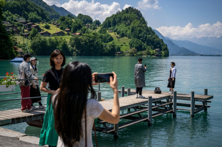 Tourists take photos on the Swiss pier made famous by South Korean Netflix series 'Crash Landing on You'