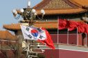 South Korea and China's flags flutter next to Tiananmen Gate in Beijing