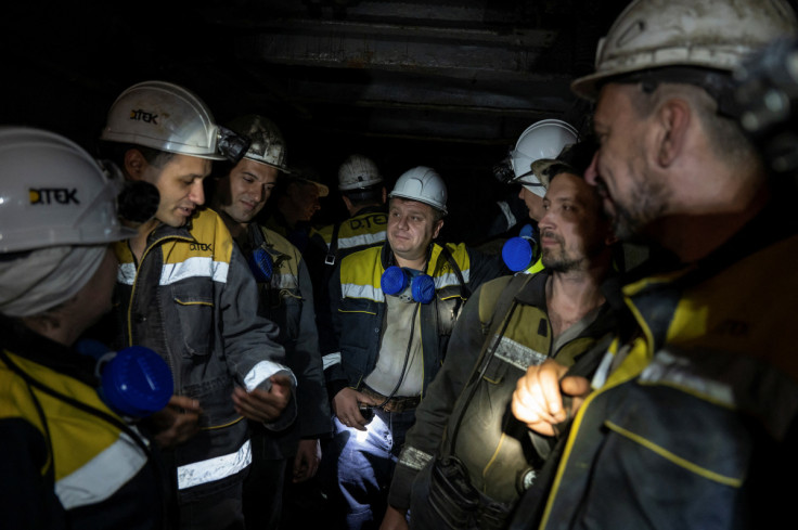 Miners talk while descending into a coal mine in Dnipropetrovsk region