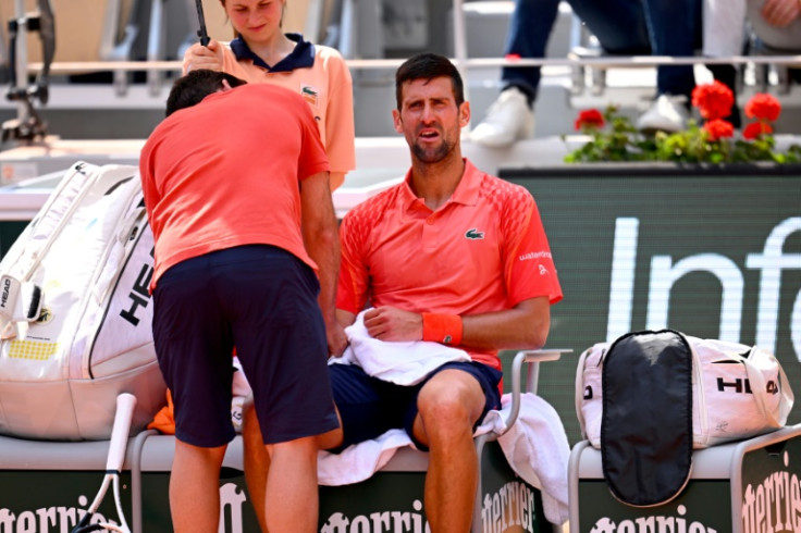 That hurts: Novak Djokovic is treated for a right wrist injury