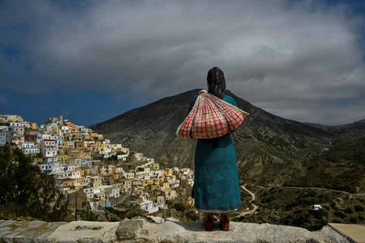 Lord of all she surveys: a sculpture of a woman in traditional costume in Olympos on the Greek island of Karpathos