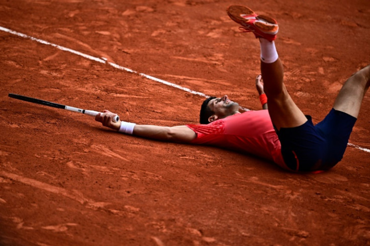 Champion: Novak Djokovic lays on the court as he celebrates his title victory