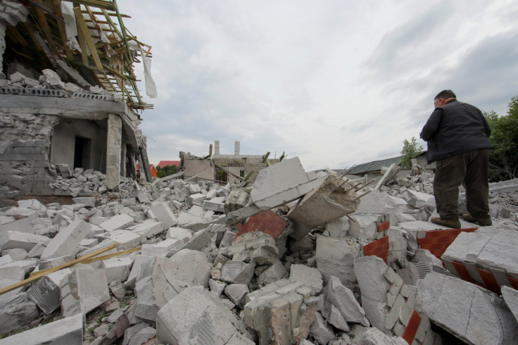 Man stands on debris of a building heavily damaged by a Russian military strike in Kharkiv region