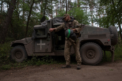 Ukrainian serviceman stands next to a HMMWV (Humvee) vehicle in Donetsk region
