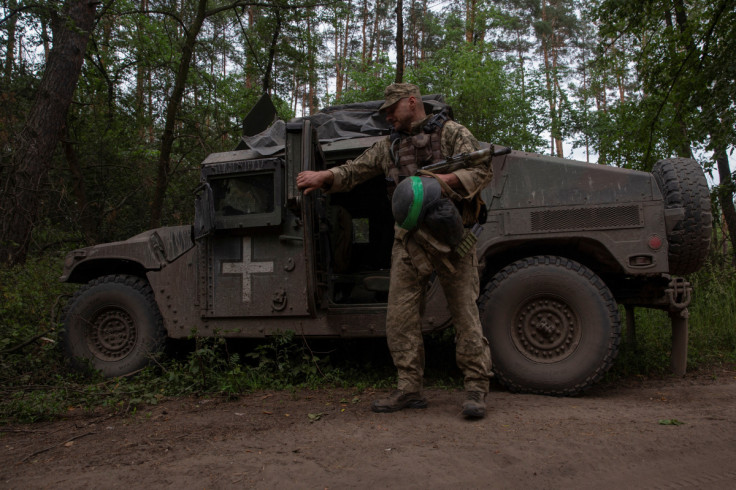 Ukrainian serviceman stands next to a HMMWV (Humvee) vehicle in Donetsk region