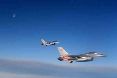 Danish F16 fighter jets demonstrate the interception of a Belgian air force transport plane as they fly over Denmark