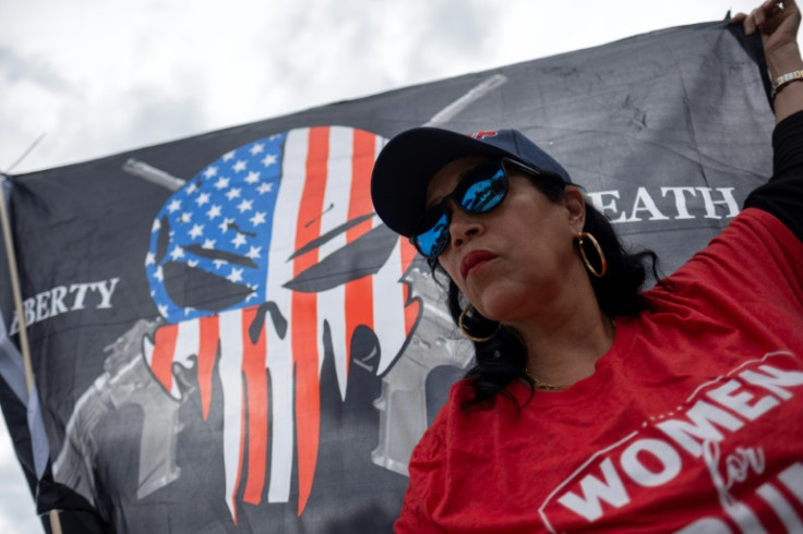 A Donald Trump supporter demonstrates outside his golf resort in Doral, Florida, on June 12, 2023