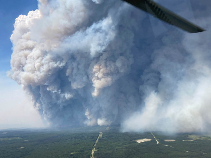 Smoke billows upwards from the Donnie Creek wildfire south of Fort Nelson