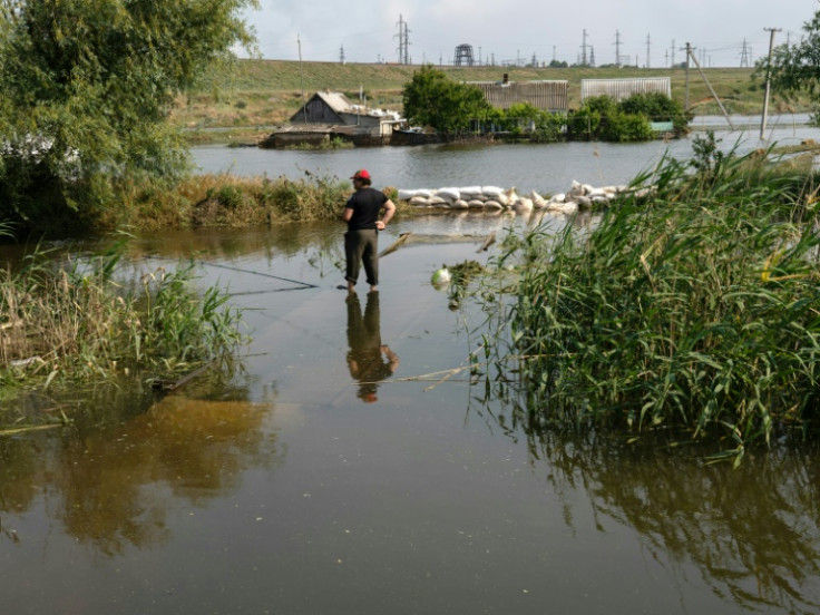 A resident fishes in a flooded area in Chornobaivka