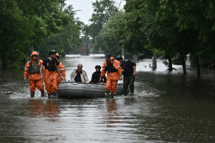 Floods triggered by damage to the Kakhovka dam have killed at least 10 people and left dozens missing