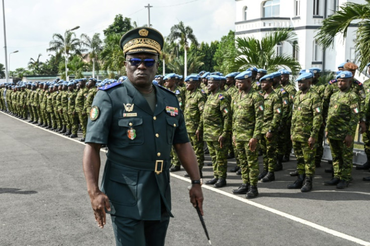 General Lassina Doumbia, chief of Staff of the Ivorian Armed Forces, reviews soldiers belonging to the UN peacekeeping mission in Mali at a ceremony in Abidjan on January 24, 2023