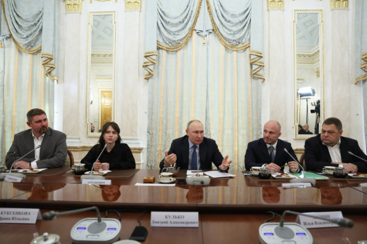 Russian President Vladimir Putin meets with war correspondents in Moscow