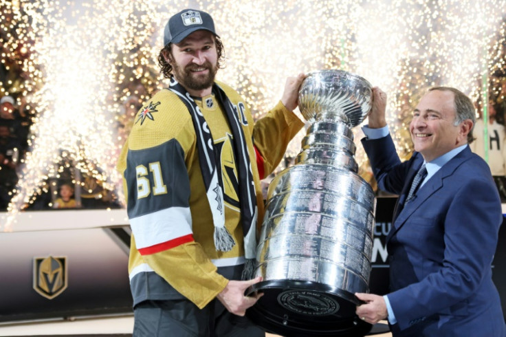 Vegas Golden Knights captain Mark Stone accepts the Stanley Cup from NHL Commissioner Gary Bettman