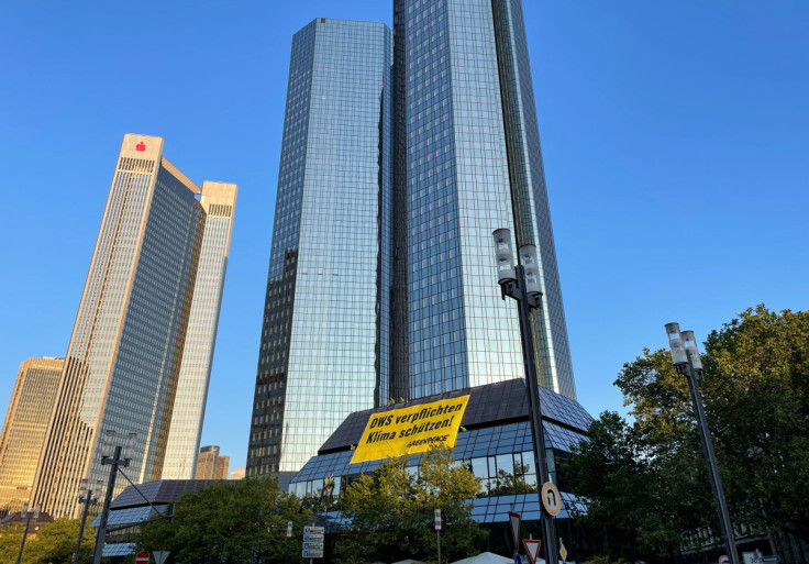 Greenpeace activists hang a banner to protest Deutsche Bank and DWS investment policies in Frankfurt