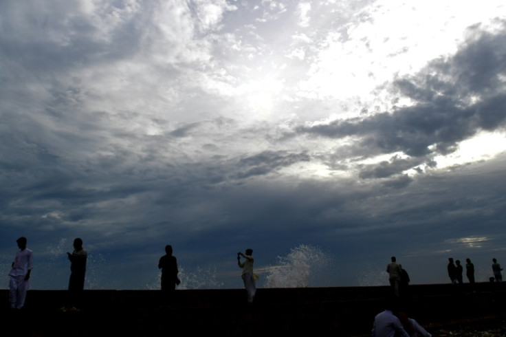 People enjoy high tide by the sea in Karachi ahead of the storm's arrival