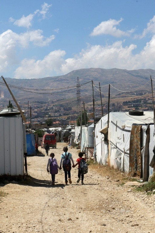 Syrian children walk to school at a refugee camp in Saadnayel in eastern Lebanon's Bekaa Valley
