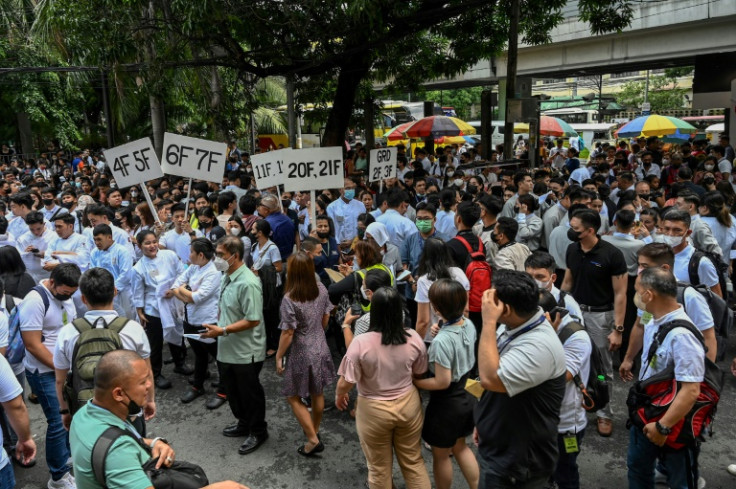Manila residents gather on a street after evacuating a building following a magnitude 6.2 earthquake
