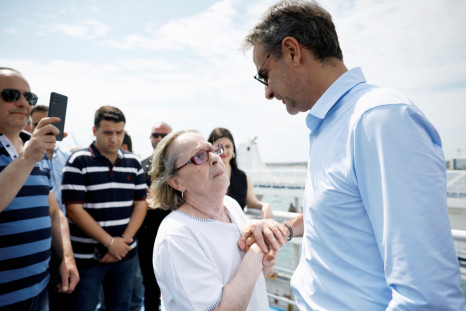 Former Greek Prime Minister Kyriakos Mitsotakis meets supporters ahead of national vote
