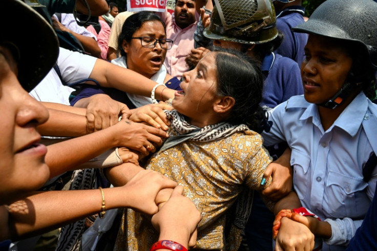 Police and activists of the Socialist Unity Centre of India (SUCI) scuffle at a demonstration to support Indian wrestlers