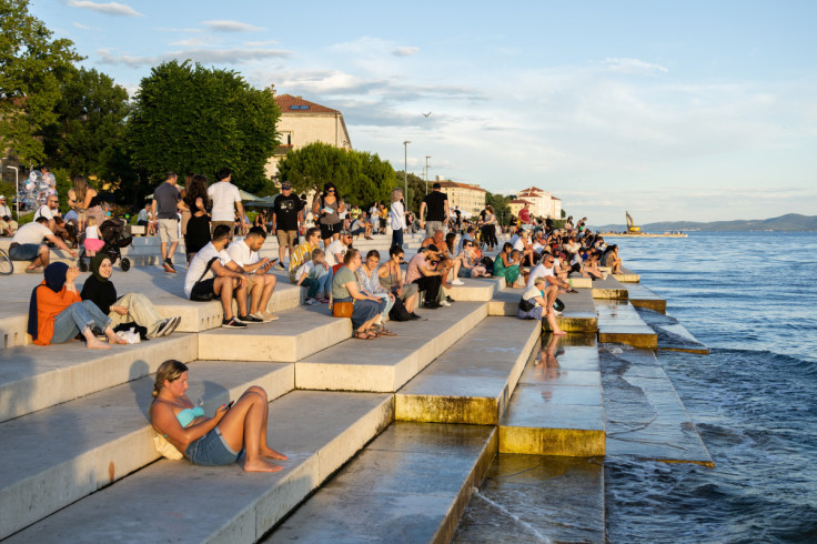 People enjoy the sunset in Zadar