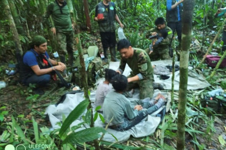 In this handout photo released on June 9, 2023, by the Colombian Presidency, members of the army attend to four Indigenous children who were found alive after spending more than a month lost in the Colombian Amazon jungle following a plane crash