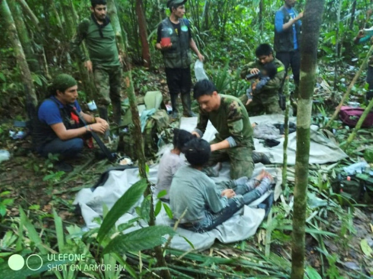 In this handout photo released on June 9, 2023, by the Colombian Presidency, members of the army attend to four Indigenous children who were found alive after spending more than a month lost in the Colombian Amazon jungle following a plane crash