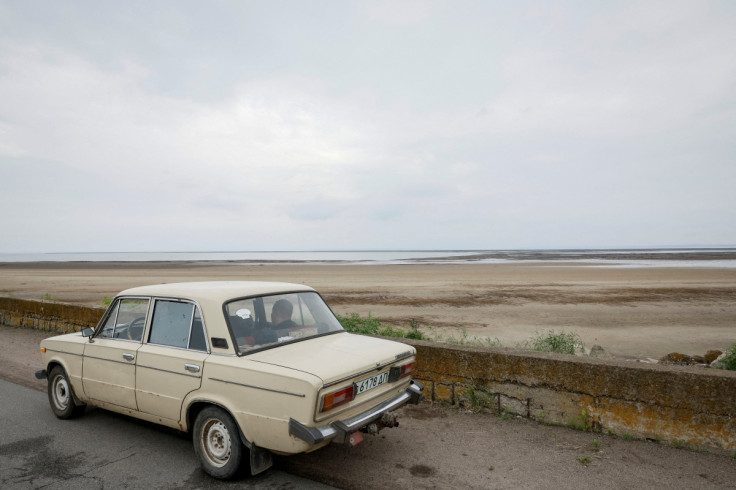 View shows the water level in Kakhovka reservoir, which sharply dropped after the destruction of the Kakhovka dam, in the village of Hrushivka, Dnipropetrovsk region