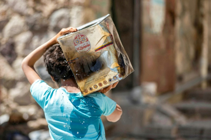 In Yemen's Taez city, boys and girls can often be seen lugging water containers nearly half their height