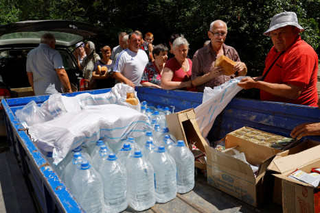 Local residents receive water and food aid in Hola Prystan