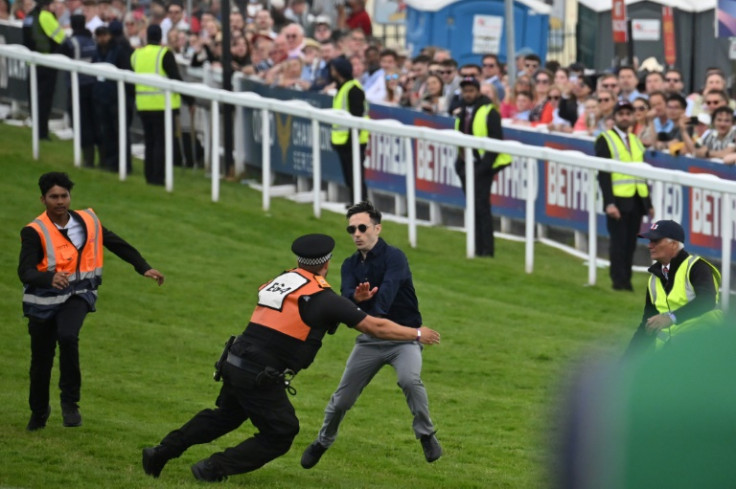 A protester runs onto the racecourse before being apprehended by police at this month's Epsom Derby