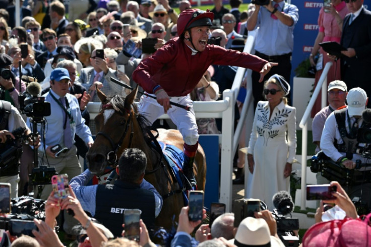 Jockey Frankie Dettori does his famous flying dismount from Soul Sister in the winner's enclosure after victory in the Oaks on the first day of the Epsom Derby Festival horse racing event in Surrey, southern England on June 2, 2023.
