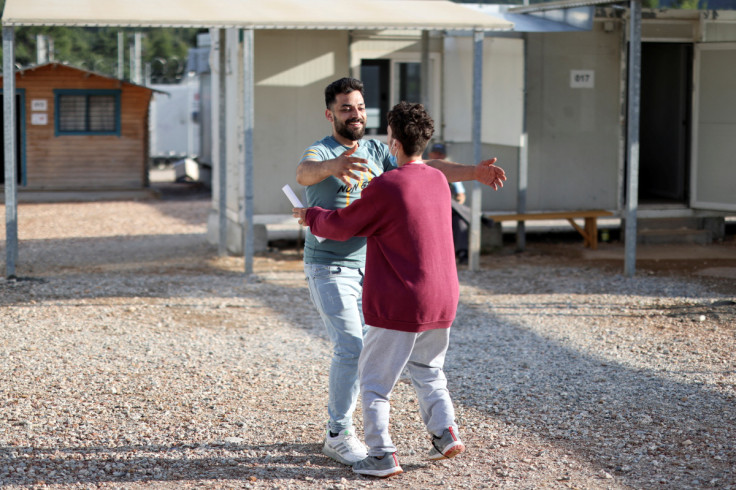 Survivors of a deadly migrant shipwreck reunite with relatives and friends in Malakasa camp