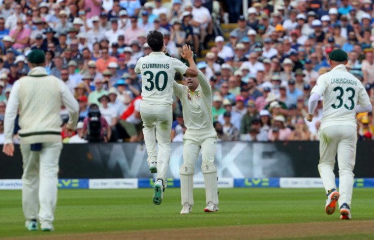 Australia captain Pat Cummins (2L) celebrates dismissing England skipper Ben Stokes (unseen) in the first Test at Edgbaston