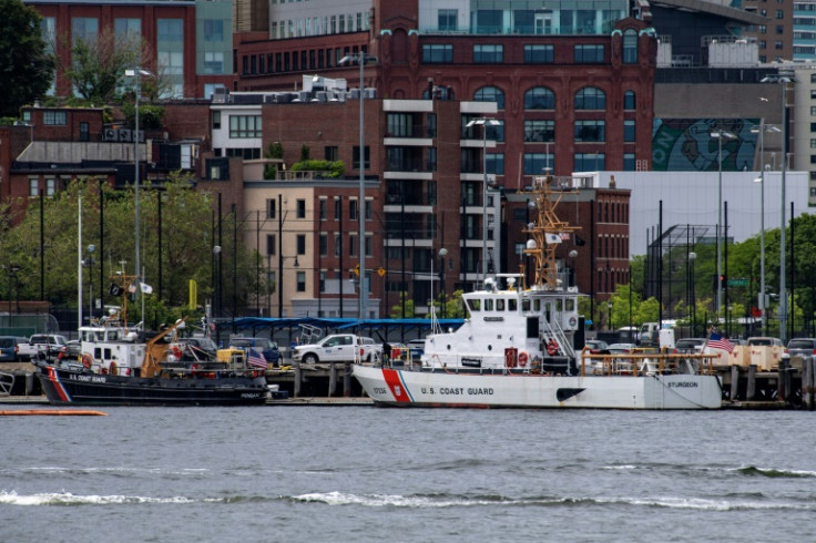 Two US Coast Guard vessels sit in port in Boston Harbor, from where authorities are mounting a search for a submersible that went missing during an expedition to the wreckage of the Titanic in the North Atlantic