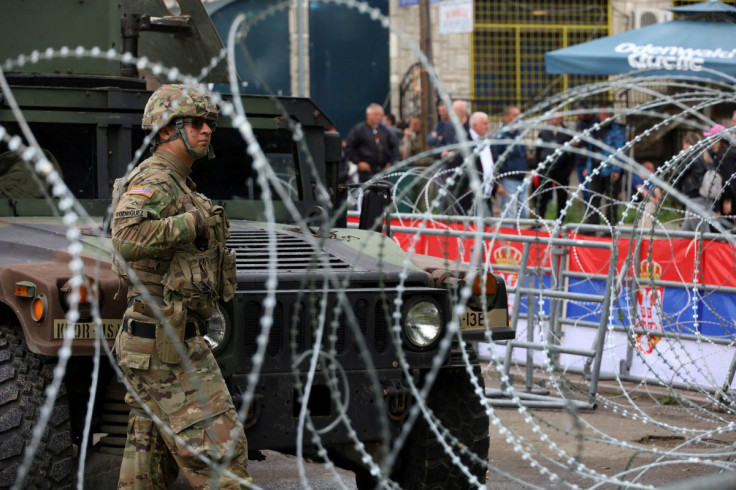 U.S. KFOR soldiers, under NATO, stand guard near a municipal office in Leposavic